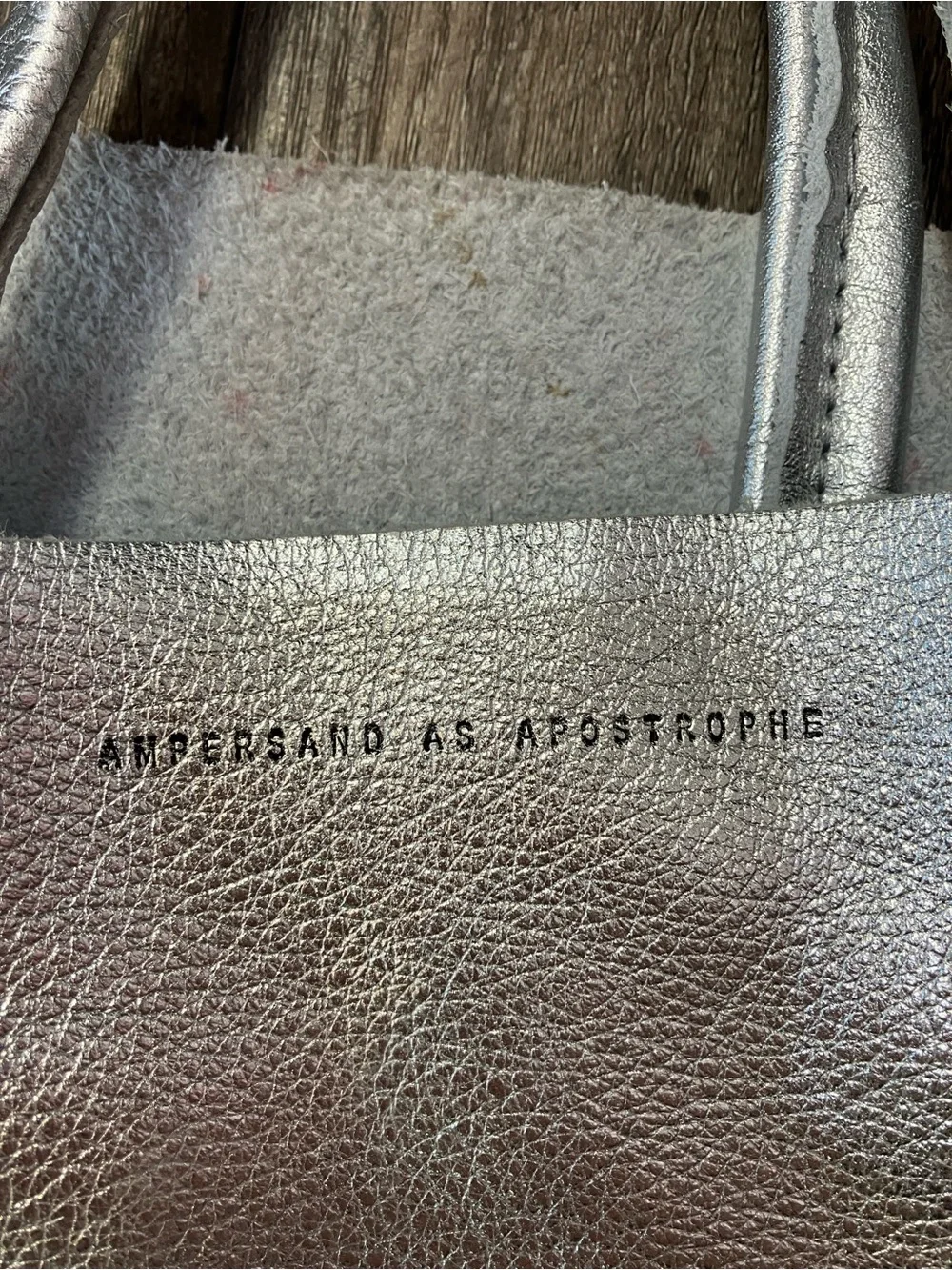 Ampersand As Apostrophe Sideways leather tote bag in a metallic silver finish